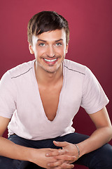 Image showing Young handsome man in a white shirt over red