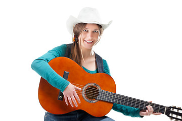 Image showing cowgirl in ahat with acoustic guitar