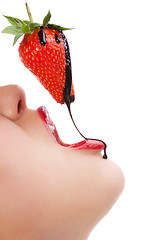 Image showing girl eating strawberry with chocolate sauc