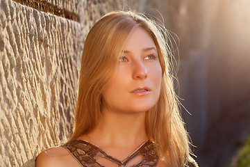 Image showing Young woman outdoors at sunset