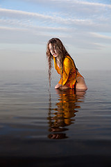 Image showing girl posing in the Water at sunset