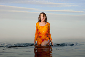 Image showing girl posing in the Water at sunset