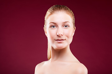 Image showing Portrait of a young lady on red