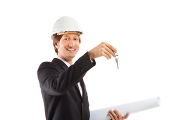 Image showing smiling engineer giving keys from apartment