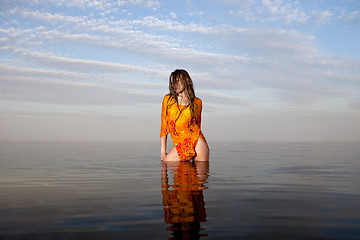 Image showing girl posing in the Water at sunset