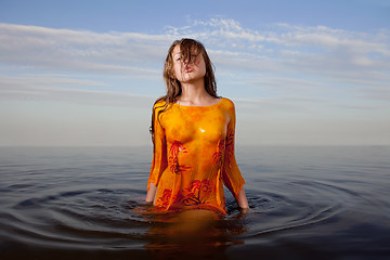 Image showing girl posing in the Water at sunset