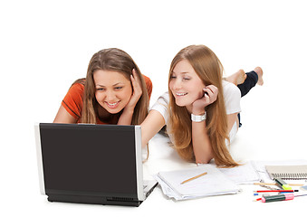 Image showing two young happy student girl work on laptop