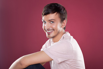 Image showing Young handsome man in a white shirt over red