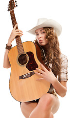 Image showing Sesy cowgirl in cowboy hat with acoustic guitar