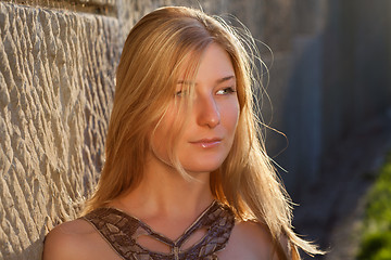 Image showing Young woman outdoors at sunset