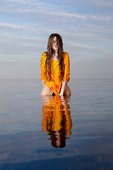 Image showing girl posing in the Water at sunset
