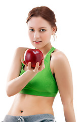 Image showing woman in sportswear with apple