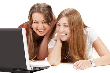 Image showing two young happy student girl work on laptop