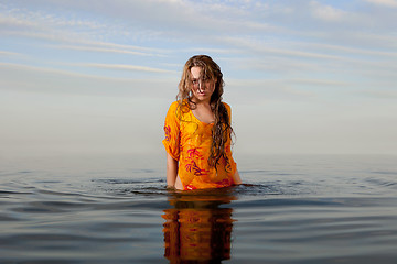 Image showing girl posing in the Water at sunset