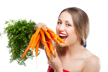 Image showing attractive woman holds bunch of carrots