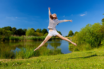 Image showing pretty young woman jumping