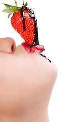 Image showing girl eating strawberry with chocolate sauc