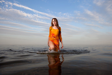 Image showing girl posing in the Water at sunset