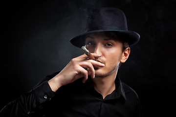 Image showing Gangster look. Man with hat and cigar.