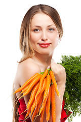 Image showing attractive woman holds bunch of carrots