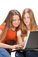 Image showing two young happy student girl work on laptop