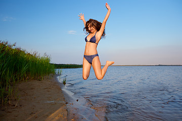 Image showing young woman on the sky and water background