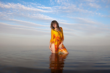 Image showing girl posing in the Water at sunset