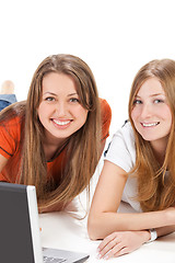 Image showing two young happy student girl work on laptop