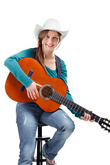 Image showing cowgirl in ahat with acoustic guitar