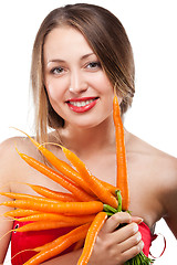 Image showing attractive woman holds bunch of carrots