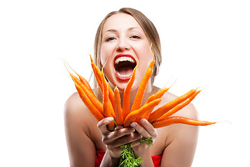 Image showing attractive woman holds bunch of carrots