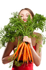Image showing attractive woman holds bunch of carrots