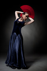 Image showing young woman dancing flamenco on black