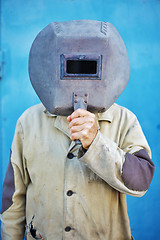 Image showing Builder - welder with old welding mask
