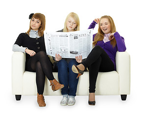 Image showing Funny girl teenagers read newspaper