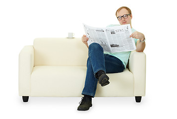 Image showing Man reading newspaper at home on sofa