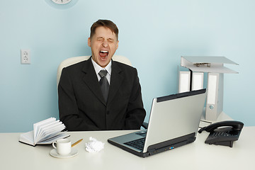 Image showing Businessman yawning from boredom and idleness