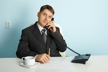 Image showing Ordinary official in office - talking on phone