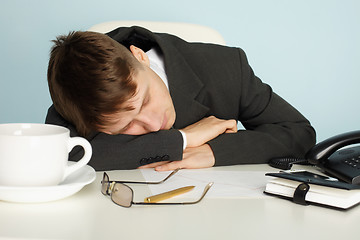 Image showing Office worker was tired and fell asleep at table