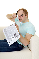 Image showing Funny man reading a job advertisement in newspaper