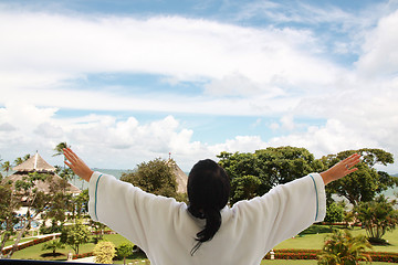 Image showing women on the balcony taking a fresh air in background sea and is