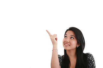 Image showing happy smiling young business woman showing blank area for sign o