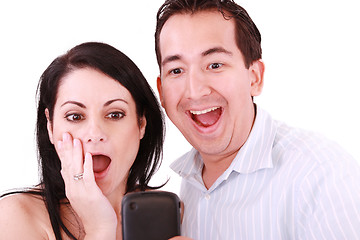 Image showing young pair was surprised, having read on mobile phone sms. 