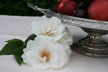 Image showing Roses beside a plate with fruits