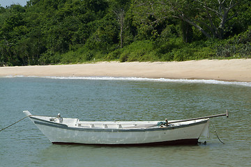 Image showing Small, white fishing boat near the beach