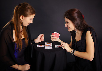 Image showing Two girls friends engaged in fortune-telling cards