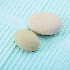 Image showing Two small round stone on towel