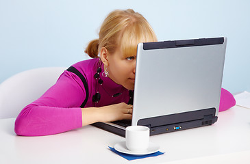 Image showing Young girl - is looking closely at laptop monitor