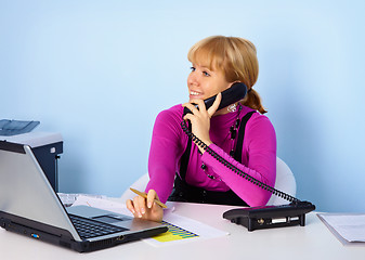 Image showing Attractive girl secretary talking on phone