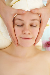 Image showing Man's hands do woman's face massage